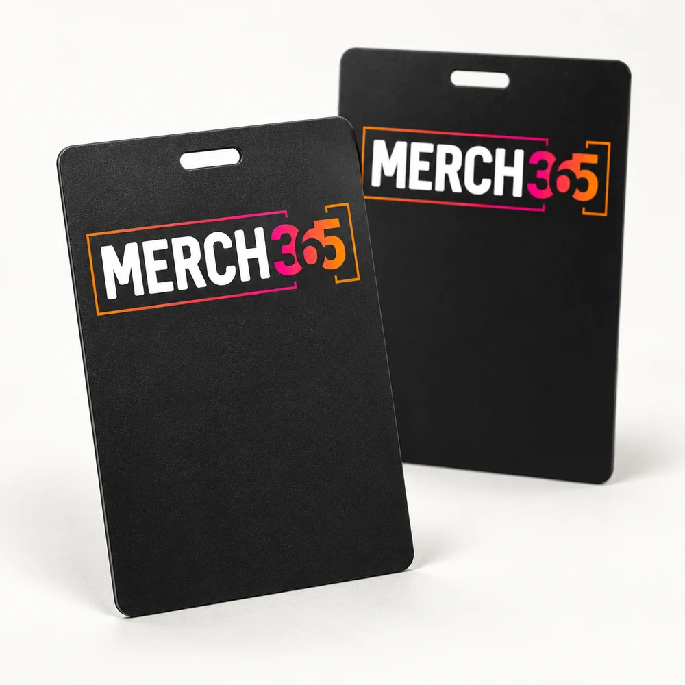 Badges with Merch365 branding on a warm white studio background — concept