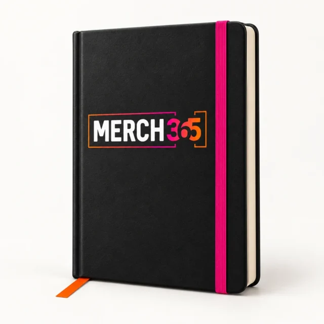 Notebooks with Merch365 branding on a warm white studio background — concept