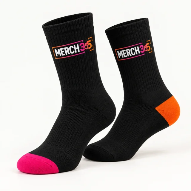 Socks with Merch365 branding on a warm white studio background — concept
