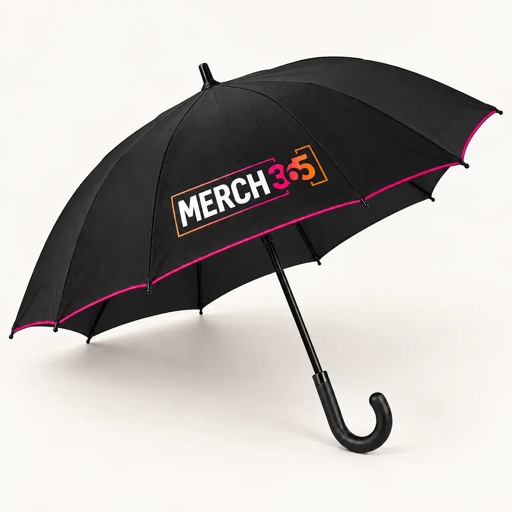 Open black umbrella with Merch365 branding and pink edging on a warm white studio background — concept
