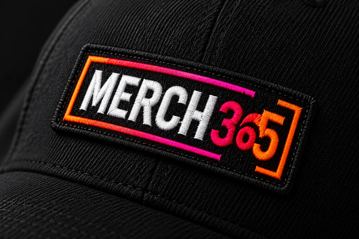Concept close-up of a woven Merch365 patch on black fabric